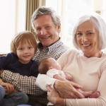 Grandparents With Grandson And Newborn Baby Granddaughter